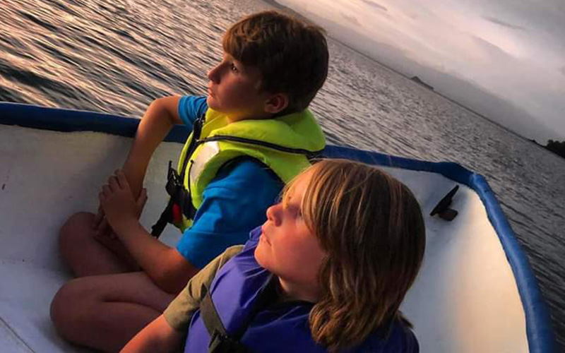 kids looking the sunset before taking their bioluminescence tour